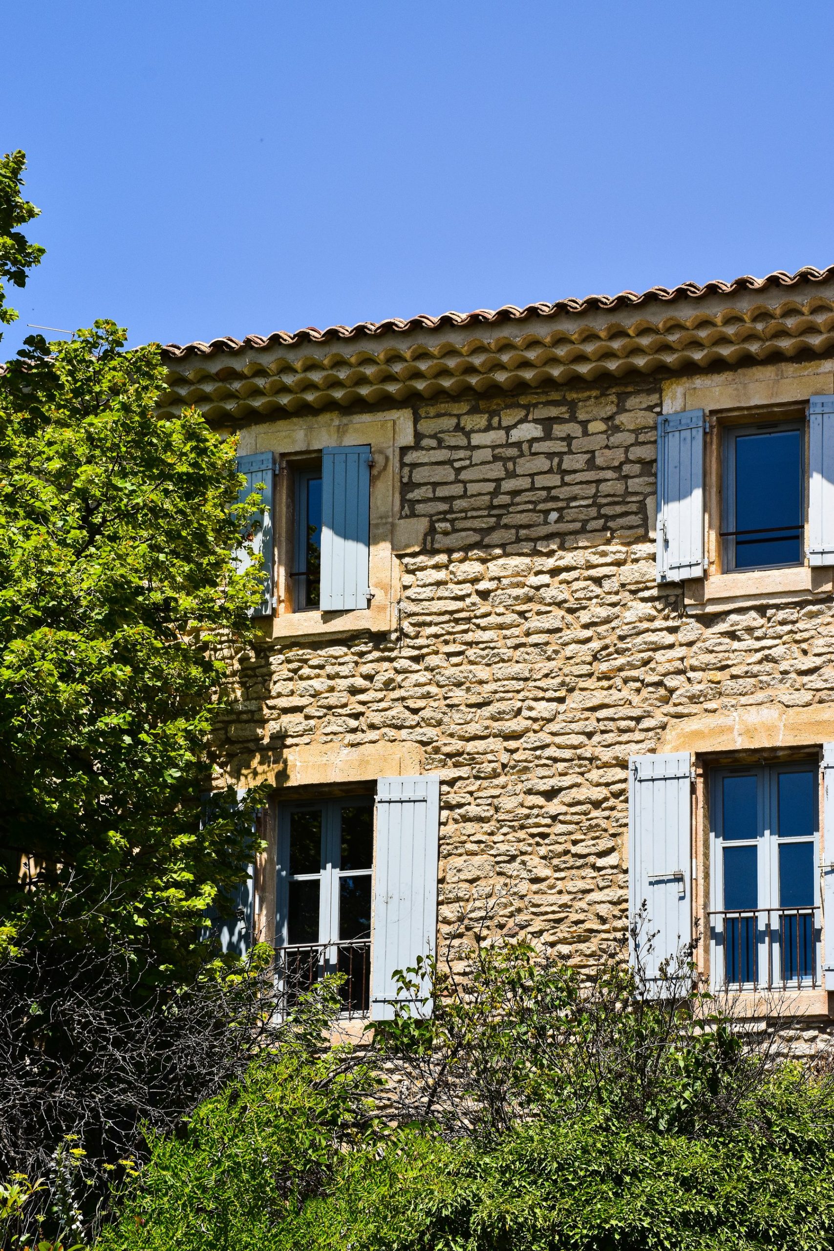 Stone walls and faded shutters